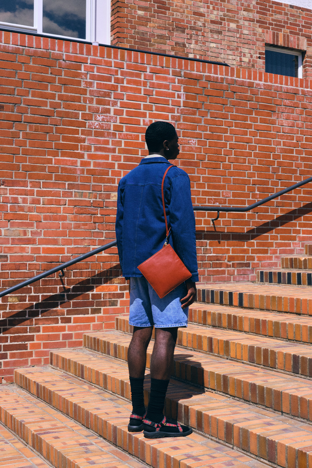 Denny Sachtleben will ‘Never Settle For Less’ — Jacket Octobre Éditions Shirt underneath Arket Shorts Carhartt Bag Malaika Raiss Archive Socks Falke Shoes Teva